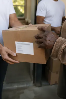 Hands Sharing Food Box in Outreach Ministry
