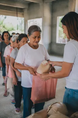 Hands Sharing Food Parcels in Church Outreach