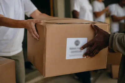 Hands Sharing Food Boxes in Ministry