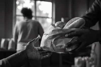 Hands Sharing Food in Church Outreach