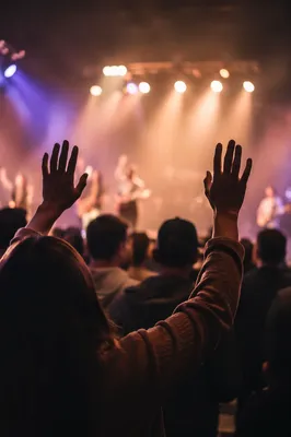 Raised Hands in Reverent Worship Lights