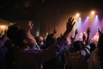Raised Hands in Church Auditorium Light