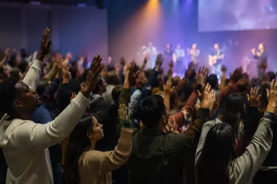 Raised Hands in Church Auditorium Worship