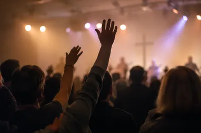 Raised Hands in Evening Worship Lights