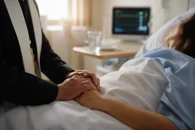 Hospital Chaplain Praying at Patient Bedside
