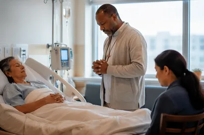 Chaplain Praying Beside Hospital Patient