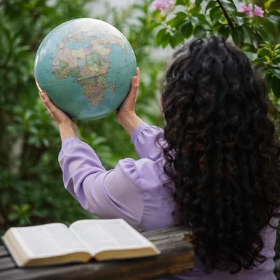 International Missions Globe Beside Open Bible