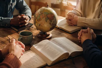 Global Missions Prayer Table with Open Bible