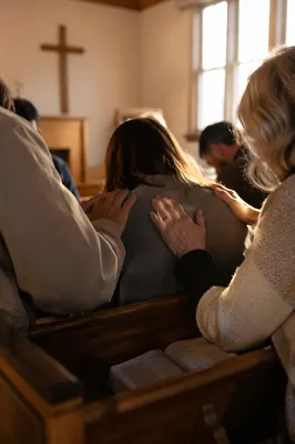 Laying Hands Prayer in Wooden Chapel