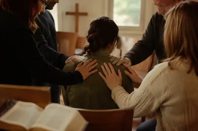 Laying Hands Prayer in Church Fellowship Room