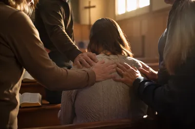 Laying Hands Prayer in Wooden Chapel