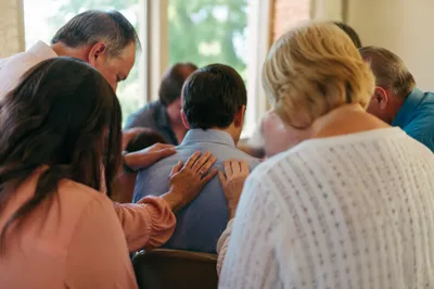 Laying Hands Prayer in Church Fellowship Hall