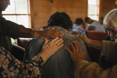 Laying Hands Prayer in Wooden Chapel