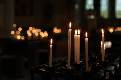 Memorial Candles Glowing in Dark Church