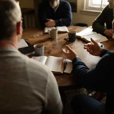 Men’s Bible Study Around Wooden Table
