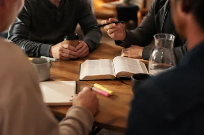 Men’s Bible Study Around Warm Wooden Table