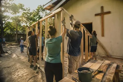 Mission Team Raising Wooden Frame Together