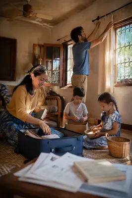 Family Unpacking in Sunlit Living Room