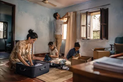 Family Unpacking in Sunlit Living Room