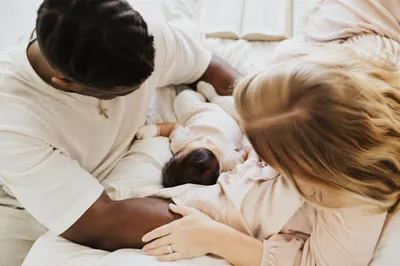 Diverse Missionary Family Resting With Baby
