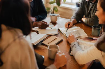 Multicultural Bible Study Around Wooden Table