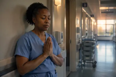 Nurse Praying in Quiet Hospital Hallway