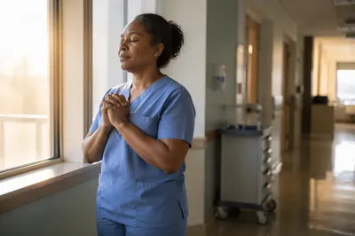 Nurse Pausing in Hospital Hallway at Dawn