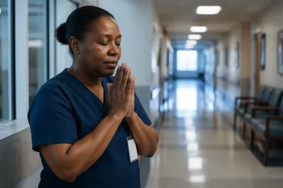 Nurse Praying in Quiet Hospital Hallway