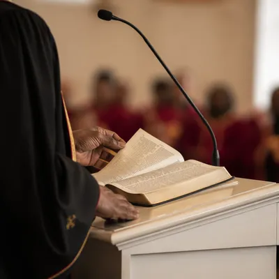 Pastor Preaching at White Church Pulpit