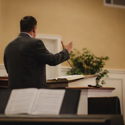 Pastor Preaching at Simple Church Pulpit