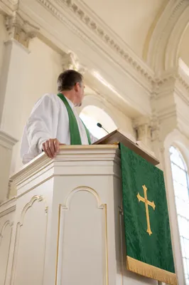 Pastor Preaching at White Church Pulpit