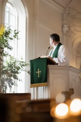 Pastor Preaching at White Church Pulpit