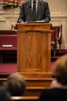 Pastor Preaching Behind Honey Oak Pulpit