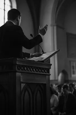 Pastor Preaching at Wooden Church Pulpit