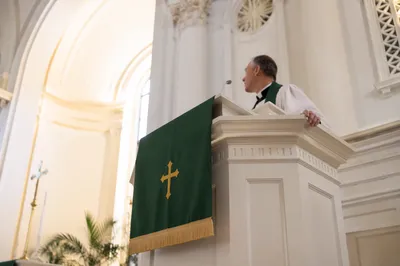 Pastor Preaching at White Church Pulpit