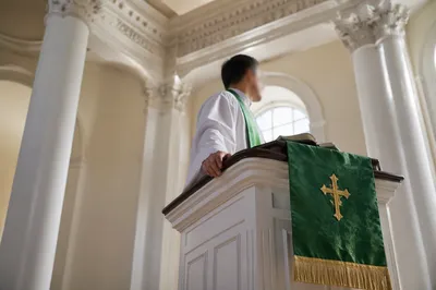 Pastor Preaching at White Church Pulpit