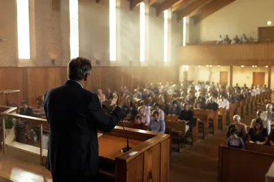 Pastor Preaching in Warm Church Sanctuary