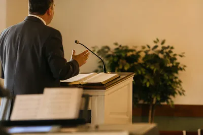 Pastor Preaching at White Church Pulpit