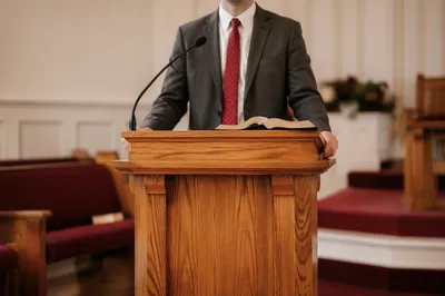 Pastor Preaching at Warm Wooden Pulpit