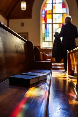 Colorful Stained Glass Light in Wooden Chapel
