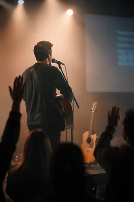 Worship Leader Singing Under Warm Stage Lights