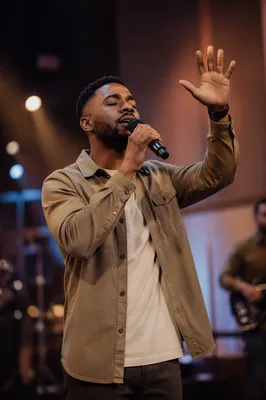 Worship Leader Singing Under Warm Stage Lights