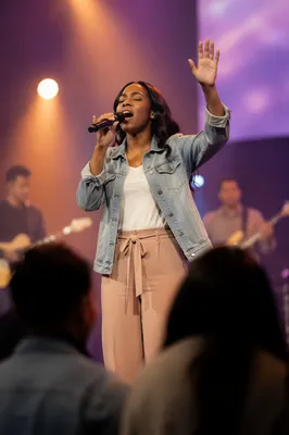 Worship Leader Singing on Lit Stage