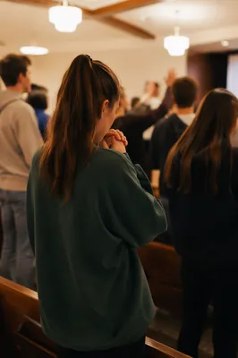 Teen Youth Group Praying in Church Hall