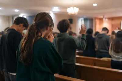 Teens Praying in Warm Church Hall