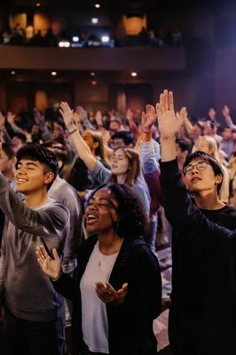 Young People Worshiping in Modern Church Hall