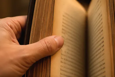 Open Aged Book in Warm Reading Light