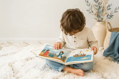 Child Reading Picture Book on Rug