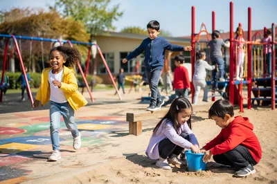 Children Playing at Sunny School Playground