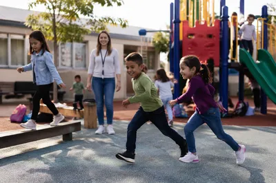 Children Playing at Sunny School Playground